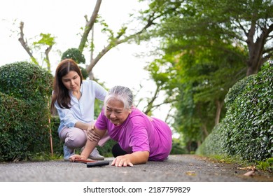 Asian Senior Woman Fell Down On Lying Floor Because Faint And Limb Weakness And Crying In Pain Form Accident And Her Daughter Came To Help Support. Concept Of Old Elderly Insurance And Health Care