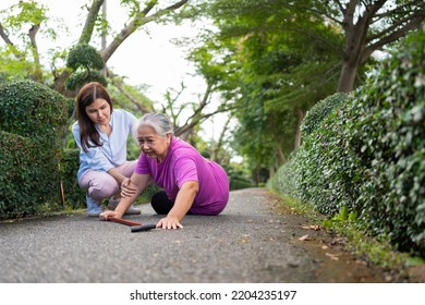 Asian Senior Woman Fell Down On Lying Floor Because Faint And Limb Weakness And Crying In Pain Form Accident And Her Daughter Came To Help Support. Concept Of Old Elderly Insurance And Health Care