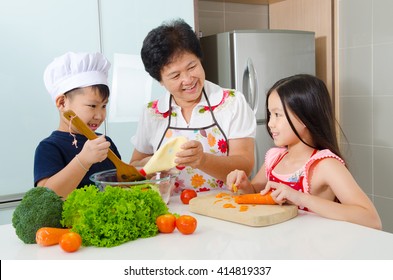 Asian Senior Woman And Grandchildren Prepared Food In The Kitchen