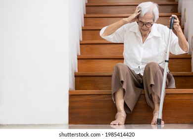 Asian Senior Woman Have A Severe Headache,disease Of Brain Tumor Or Brain Cancer,pain In Her Head,sick Old Elderly Sits On The Floor Of The Stairs To Rest Her Vertigo,dizzy,tendency To Fall Or Stagger