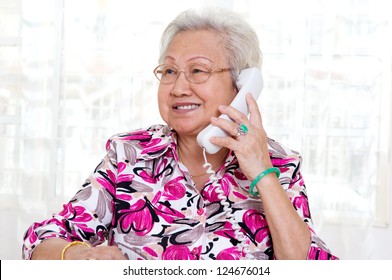 Asian Senior Woman In Her 70s Talking On The Phone