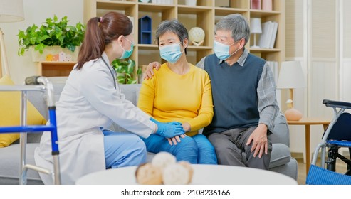 Asian Senior Woman With Husband Accompany And Female Doctor Taking Care Of Her At Home - They Are Wearing Face Mask