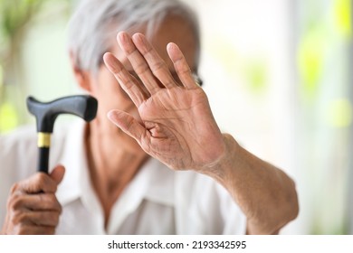 Asian senior woman making stop gesture with palm,against domestic violence,old people raising hand to show sign,stop bullying the elderly,physical harm,psychological damage,abuse,mistreatment concept - Shutterstock ID 2193342595