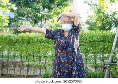 Asian Senior Woman With Mask Protect Coronavirus Exercise With Happy In Park, Healthy Strong Medical Concept