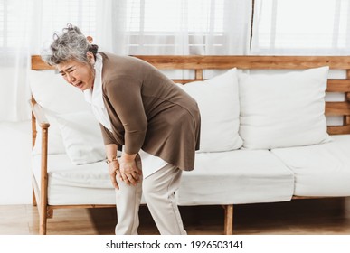 Asian Senior Woman Pain From Knee Ache Alone At Home. Elderly Woman Pain And Hurt From Osteoporosis Sickness Or Muscle Injury. Old Adult Life Insurance With Health Care, Treatment Or Therapy Concept