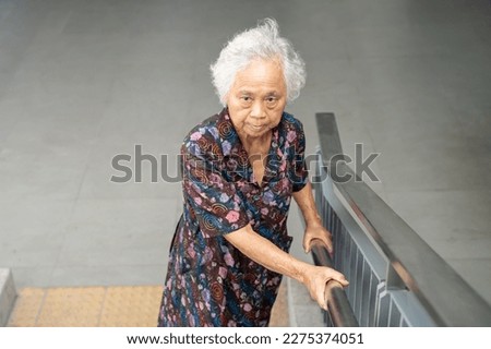 Asian senior woman patient use slope walkway handle security with help support assistant, healthy strong medical concept.