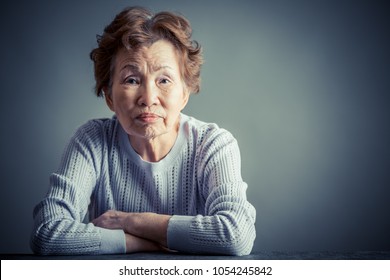 Asian Senior Woman Serious Face In Studio