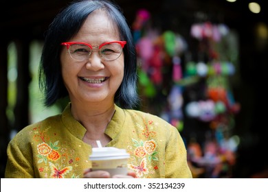 Asian Senior Woman Smiling With  A Coffee Cup