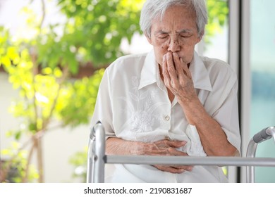 Asian Senior Woman With Stomachache,old Elderly Holding Her Abdomen,covering Mouth With Hand,discomfort In The Stomach Associated With Difficulty In Digesting Food,indigestion After Eating Fastfood