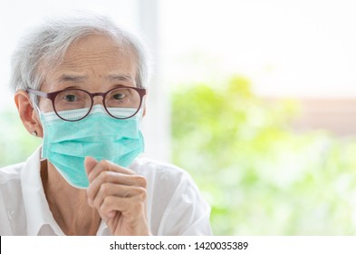 Asian senior woman suffer from cough with face mask protection,elderly woman wearing face mask because of air pollution,Sick old people with medical mask;concept of pollution,dust allergies,Covid-19 - Powered by Shutterstock