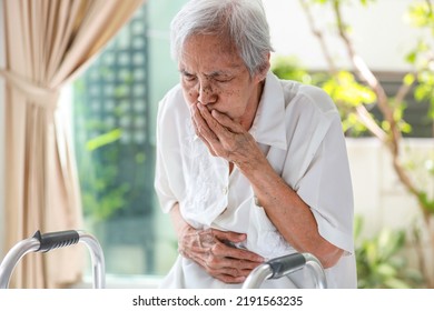 Asian Senior Woman Suffering From Abdominal Bloating,colic In Abdomen,flatulence,accumulation Of Gas,frequent Belching,old Elderly With Nausea,vomiting,food Poisoning,stomach Heartburn,gastric Problem