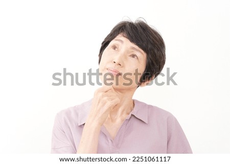 Asian senior woman thinking in white background