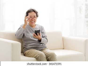 Asian Senior Woman Touching The Smart Phone