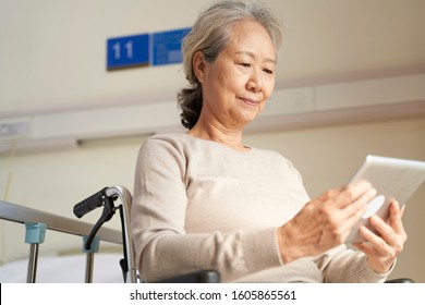 asian senior woman using digital tablet in nursing home or hospital ward - Powered by Shutterstock