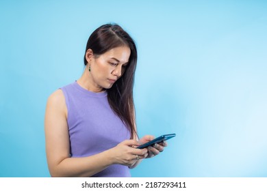 Asian Senior Woman Using Smart Phone With Blue Background.