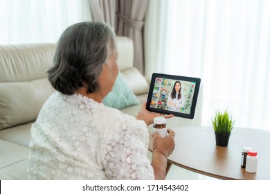 Asian senior woman using video conference, make online consultation with pharmacy consulting about illness and medication via video call. Telehealth, Telemedicine and online hospital.