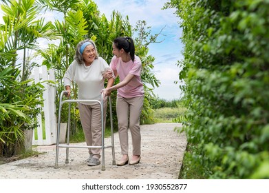 Asian senior woman walking with pian by walker, she living with Asian female physical therapist (nurse) take care.