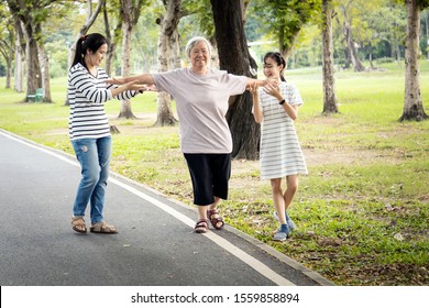 Asian Senior Woman Walking In A Straight Line,follow White Line On The Floor And Trying To Balance,elderly People Exercise With Arms Outstretched,testing And Risk Fall Prevention,balance The Body 