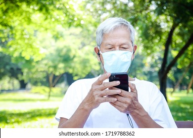 Asian seniors wearing masks use a smartphone to chat with their family via video call. Concept of social distance, prevention of virus infection. copy space - Powered by Shutterstock