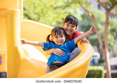 Asian Siblings playing at the playground and smiled and laughed happy - Powered by Shutterstock