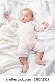 Asian Sleeping Baby On Back On White Bed