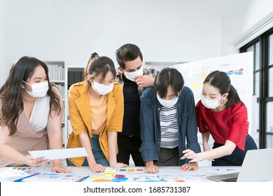 Asian Small Business Startup Multiracial Fighting Action Posture With Laptop And Chart Paper Everyone Mask For Covid19 Protection Corona Flu Prevent Healty Ideas Concept Office Background