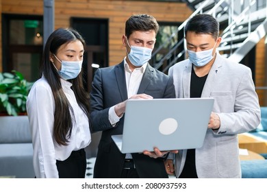 Asian Small Business Startup Multiracial Brainstorming Meeting With Laptop All Covid19 Protection Masks Corona Flu Prevent Healthy Ideas Concept Office.