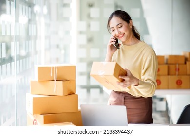 Asian SME business women use laptop computer checking customer order online shipping boxes at home. Starting Small business entrepreneur SME freelance. Online business, Work at home concept. - Shutterstock ID 2138394437