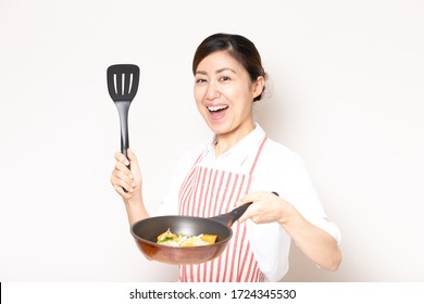 Asian Smiling Woman Enjoying Food With Frying Pan