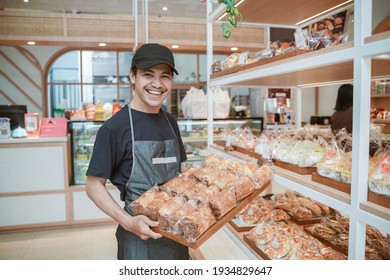 Asian Smiling Worker At The Bakery Shop