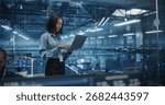 Asian Software Developer Analyze System Performance Metrics on a Laptop Inside a Modern Data Center. Young Female Manager Ensuring Efficient Operations for Critical Infrastructure