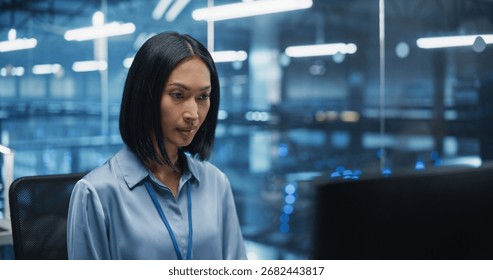 Asian Software Developer Analyze System Performance Metrics on a Computer Inside a Modern Data Center. Young Female Manager Ensuring Efficient Operations for Critical Infrastructure