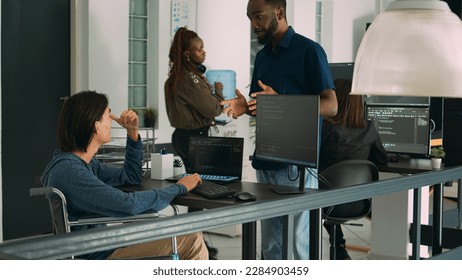 Asian software developer with chronic disability working on server coding, analyzing html language and script on terminal window. Wheelchair user with impairment working on it system.
