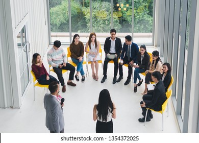 Asian Speaker male and female speaking at seminars and workshops to the people in the meeting. By the participants of the seminar and training sitting round a semicircle. Top view. - Powered by Shutterstock