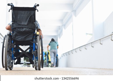 Asian Special Child On Wheelchair Is Pushing His Car On The Ramp In The Hospital Together With Others, Life In The Education Age Of Disabled Children, Happy Disabled Kid Concept.