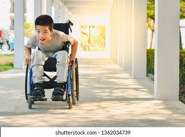 Asian special child on wheelchair is smile happily on ramp for disabled people background and orange light, Life in the education age of disabled children, Happy disabled kid concept. - Powered by Shutterstock