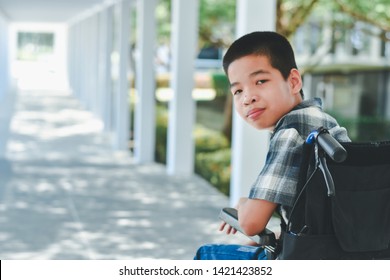 Asian special child on wheelchair is smile happily on ramp for disabled people background and orange light, Life in the education age of disabled children, Happy disabled kid concept. - Powered by Shutterstock