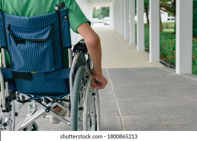 Asian Special Child On Wheelchair Wearing Green Shirt Learn How To Use Wheelchairs On Ramps For People With Disabilities,Lifestyle In The Education Age Of Disabled Children,Happy Disabled Kid Concept.