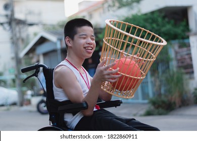 Asian Special Child On Wheelchair Playing Chair Ball/ Basketball To Strengthen Muscles,Lifestyle Of Disabled Child,Life In The Education Age Of Children,Happy Disability Kid With Home School Concept.