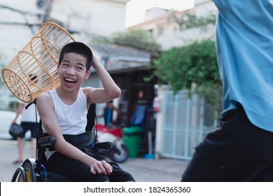 Asian Special Child On Wheelchair Playing Chair Ball/ Basketball To Strengthen Muscles,Lifestyle Of Disabled Child,Life In The Education Age Of Children,Happy Disability Kid With Home School Concept.