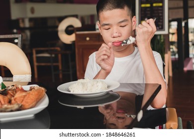 Asian Special Child On Wheelchair Eating Breakfast By Themselves,The Skills To Practice Muscle Development, Disabled Children's Lifestyle, Life In The Education Age, Happy Disability Kid Concept.