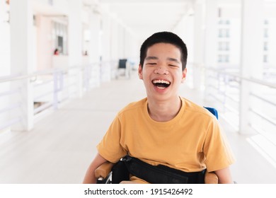 Asian Special Child On Wheelchair Is Smiling Face As Happiness On Ramp For Disabled People Background In Hospital, Lifestyle In The Education Age Of Disabled Children, Happy Disability Kid Concept.