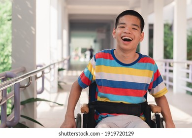 Asian special child on wheelchair is smiling face as happiness on ramp for disabled people background in hospital, Lifestyle in the education age of disabled children, Happy disability kid concept.
