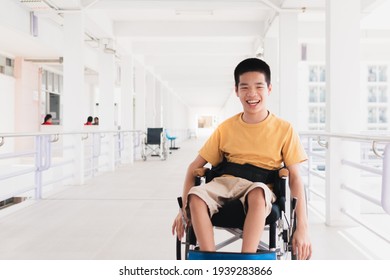 Asian special child on wheelchair is smiling face as happiness on ramp for disabled people background in hospital, Lifestyle in the education age of disabled children, Happy disability kid concept.