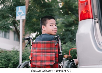 Asian Special Child On Wheelchair By The Car Door Going Up On A Car Parked In A Disabled Parking Space, Using A Disabled  Children Vehicle, Happy Special Need Kids Concept.