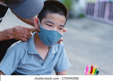 Asian Special Need Child On Wheelchair Wearing A Cotton Mask By Parent,Boy Felt Uncomfortable And Didn't Want To Wear A Guise, Study And Working At Home For Safety From Covid 19, Education Distancing.