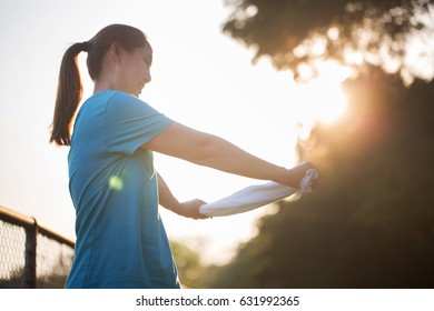 Asian sport woman exercising in the park - Shutterstock ID 631992365