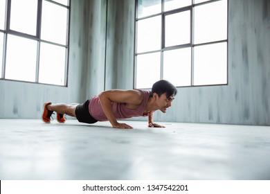 Asian Sportsman Doing Push Up At The Fitness Centre