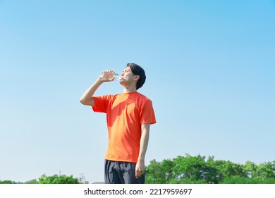 Asian Sportsman Drinking Water Outdoor