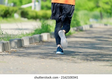 Asian Sportsman Running In The Fresh Greens, No Face